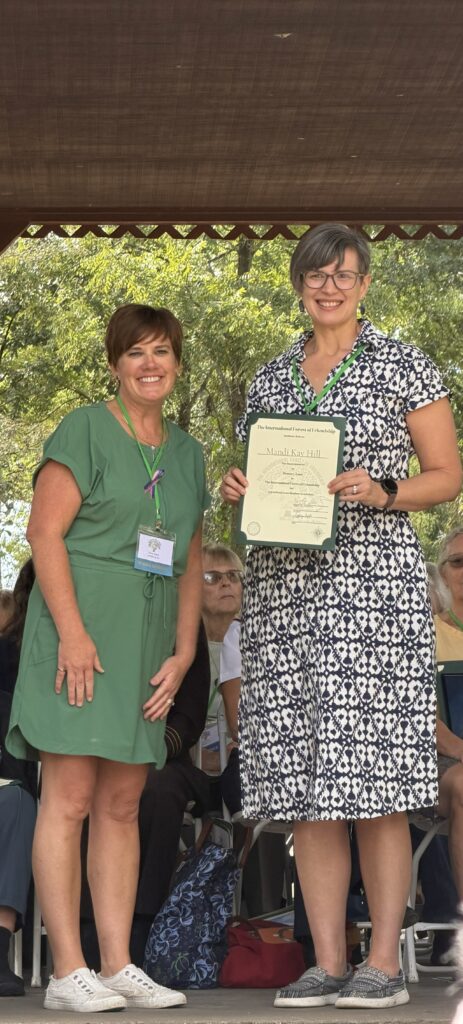 Mandi Hill shows off her Forest of Friendship certificate.