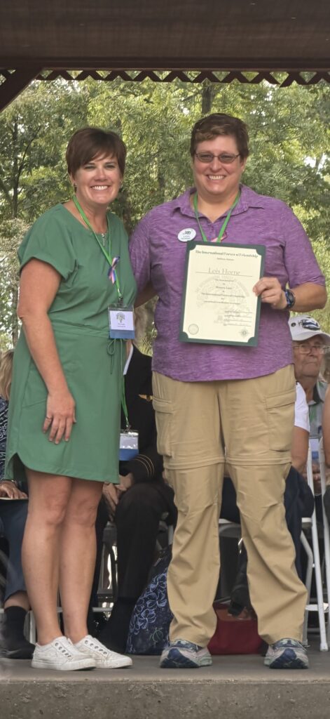 Lois Horne receives her Forest of Friendship certificate.
